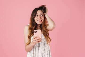 Image of joyful cute woman using cellphone and looking aside