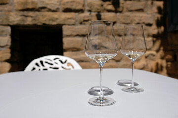 Wine tasting event - two white wine glasses on a table on a sunny day