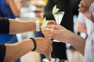 Hands catching glasses of cocktails
