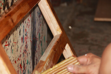 Carpenter working on woodworking machines in carpentry shop