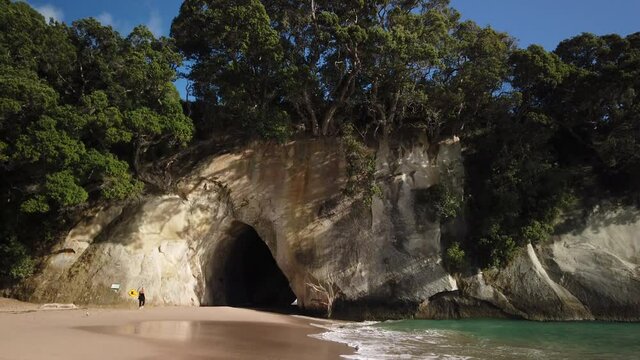 4k hand held stationary motion of the rock formation know as Cathedral Cove on the coromandel Peninsula,tourist destination that became famous from a a movie film location,north island,New Zealand