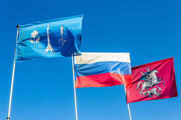 Blowing Flags of Rocket Monument to the Conquerors of Space, Russian Federation and Moscow City.