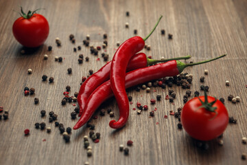 Red ripe fruits of chili pepper and cherry tomato with peppercorns