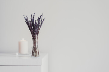 Vase with dried lavender and one white burning candle on wooden table. Simple home decor. Minimal style. Aromatherapy concept, space for text - 355152203