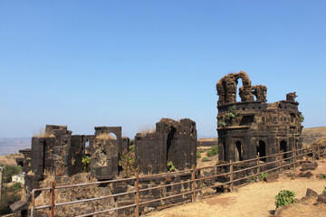 Fototapeta premium Ruins of fort walls. Raigad Fort, Maharashtra, India. 350-year-old majestic fort of Chhatrapati Shivaji with 1737 steps to climb, 1,300 acres and largest fort complexes in India