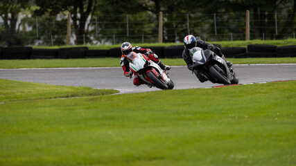 A shot of two racing bikes cornering as they circuit a track