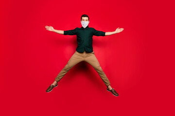 Full length body size view of nice attractive guy wearing safety mask jumping healthy air environment stop pandemia concept isolated bright vivid shine vibrant red color background