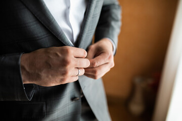 Obraz premium Dressing a man. Fastens buttons.