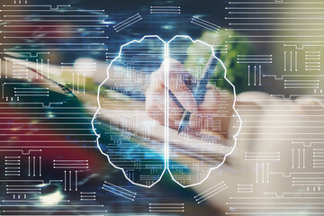 Multi exposure of writing hand on background with brain hologram. Concept of self learning.