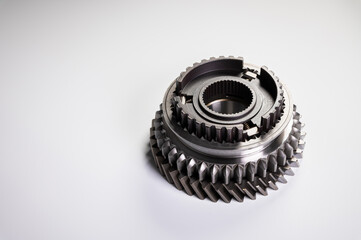 New parts on a gray background. Gears of gear shifting torque transmission. Conceptually mechanical background. Shiny gear box gear teeth
