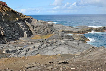 Layers of rocks resulting from lava flow - volcanic shore on the island of Gran Canaria, Canary...