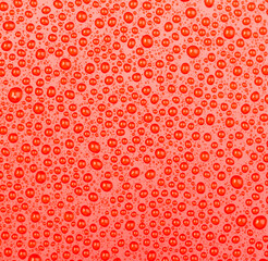 Abstract water drop on red background.