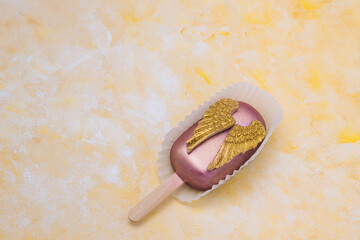 Cake pop with chocolate decorative golden wings