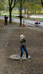 Fototapeta premium Brave little boy walking on a rope bridge
