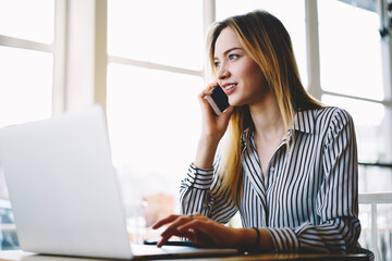 Pensive professional female recruiter making job offer to candidate through mobile conversation...