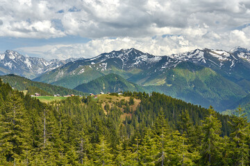 Obraz premium Landscape of Pokut Plateau with snowy mountains, clouds and green nature. Taken from Sal Plateau, Kackar Mountains, Rize, Black Sea / Karadeniz region of Turkey