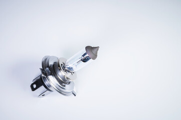 One new halogen light with an H4 cinder on a grey gradient background. New car parts for external...