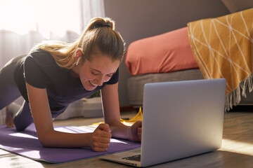 Young woman taking part in online fitness class