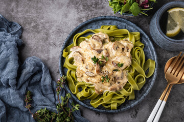 fettuccine pasta with cream sauce with mushrooms and parmesan, top view, copy space