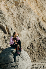 Fototapeta premium Beautiful asian woman sit on Moeraki Boulders, South Island, New Zealand.
