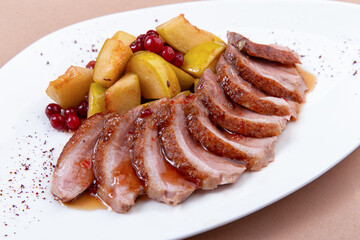 fried duck fillet with pear on a plate. close-up.