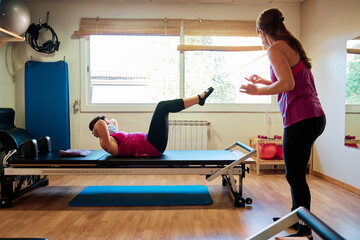 group of mature women doing excercise, Pilates and Yoga with social distancing and face mask