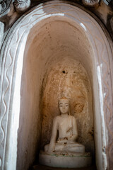 Small white Buddha figure inside a pagoda. Pagoda forest at Shwe Inn Dein Pagoda, Inle lake region, Myanmar, Burma, south east Asia