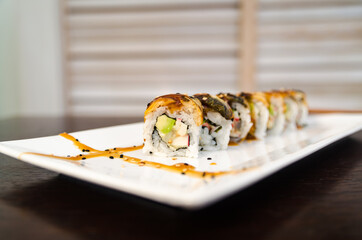 Delicious crab sushi rolls on white plate