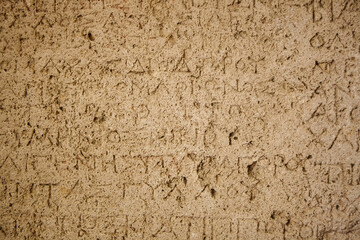 Ancient inscriptions on stone, close-up.