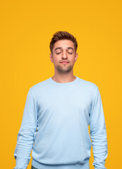 Young relaxed man in modern studio