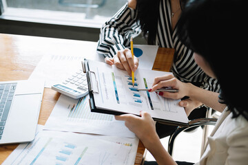 Asian business adviser meeting to analyze and discuss the situation on the financial report in the meeting room.Investment Consultant,Financial advisor and accounting concept