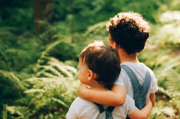 Two little boys in forest.