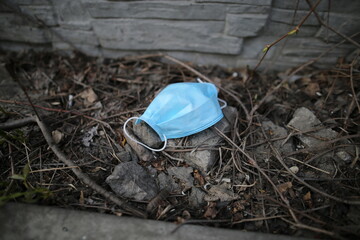 Disposable face mask. Surgical masks are used carelessly scattered on the street. Do not throw away...