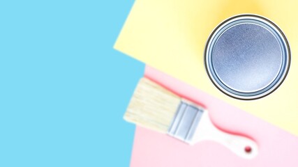 Metal round can on colorful background with new paint brush. House renovation. Hobby