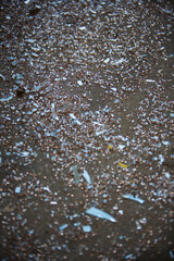 Fototapeta na wymiar shards of broken glass on the floor of the old asphalt
