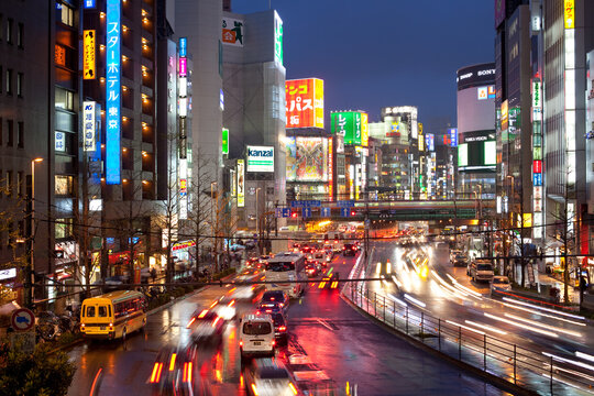 Shinjuku, Tokyo, Kanto Region, Honshu, Japan, Asia - Traffic at the bustling district of Shinjuku full with advertising signs.