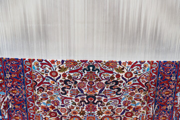Silk Carpet on a loom, traditional carpet weaving in Uzbekistan