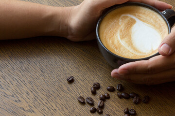 Female hands holding cups of coffee