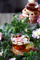 Selective focus. Macro. Rosehip tea. Hot rosehip drink. Flowers and rose hips.