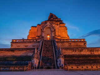 view evening of ruin pagoda lanna style art 13th. Century with blue sky background, Wat Chedi Luang buddhist temple in Chiang Mai, northern of Thailand.