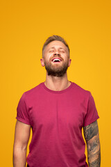 Glad bearded guy laughing with closed eyes