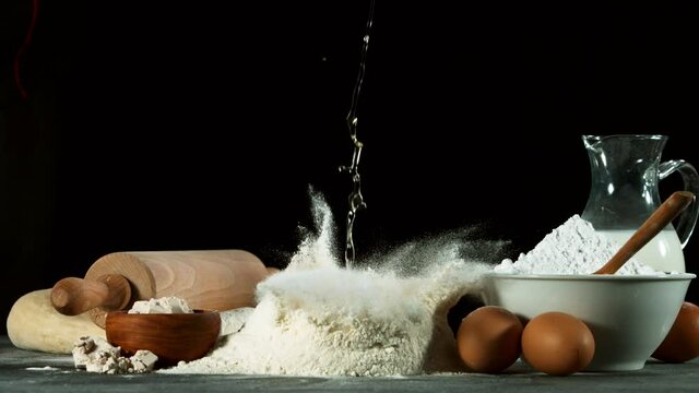 Super slow motion of raw egg falling into pile of flour. Filmed on high speed cinema camera, 1000 fps.