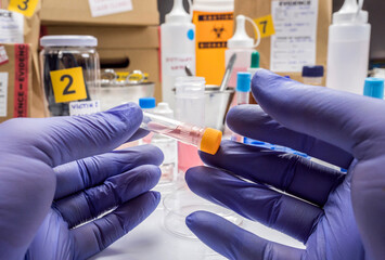 Specialized criminalistic police performs hematological analysis with forensic test kit in a murder in a crime lab, conceptual image