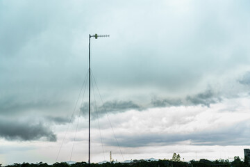 Television antennas rise into the evening sky