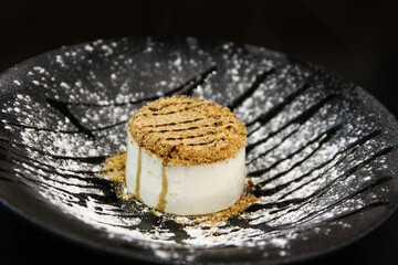 Cheesecake with crumbs on a decorated plate