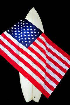 USA flag on a white surfboard, American stars & stripes & a straw cowboy hat. This is known as the Red, white, and blue. Surfing is a lifestyle. Patriot.