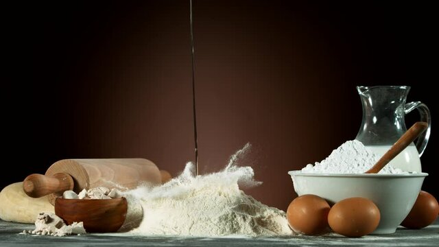 Super slow motion of raw egg falling into pile of flour. Filmed on high speed cinema camera, 1000 fps.