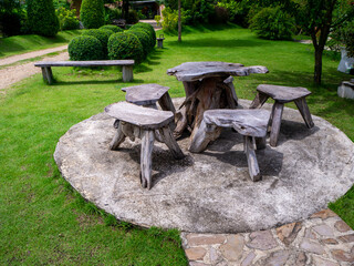 The Old wooden table set  in the green garden.