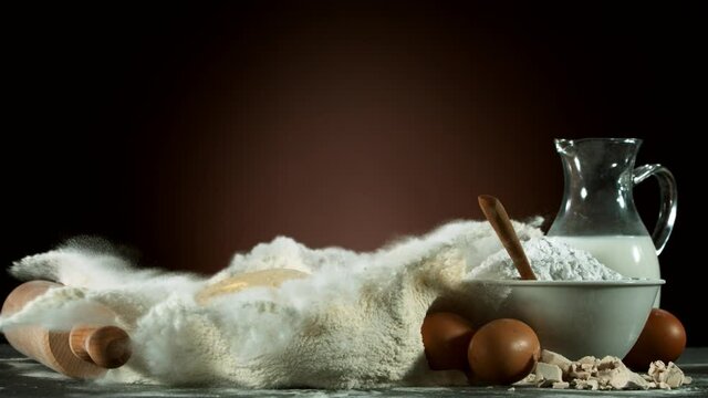 Super slow motion of raw egg falling into pile of flour. Filmed on high speed cinema camera, 1000 fps.