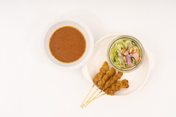 Pork satay - Grilled pork served with peanut sauce or sweet and sour sauce - Asian food style on white background.